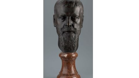 Black head of the bust on a brown marble base